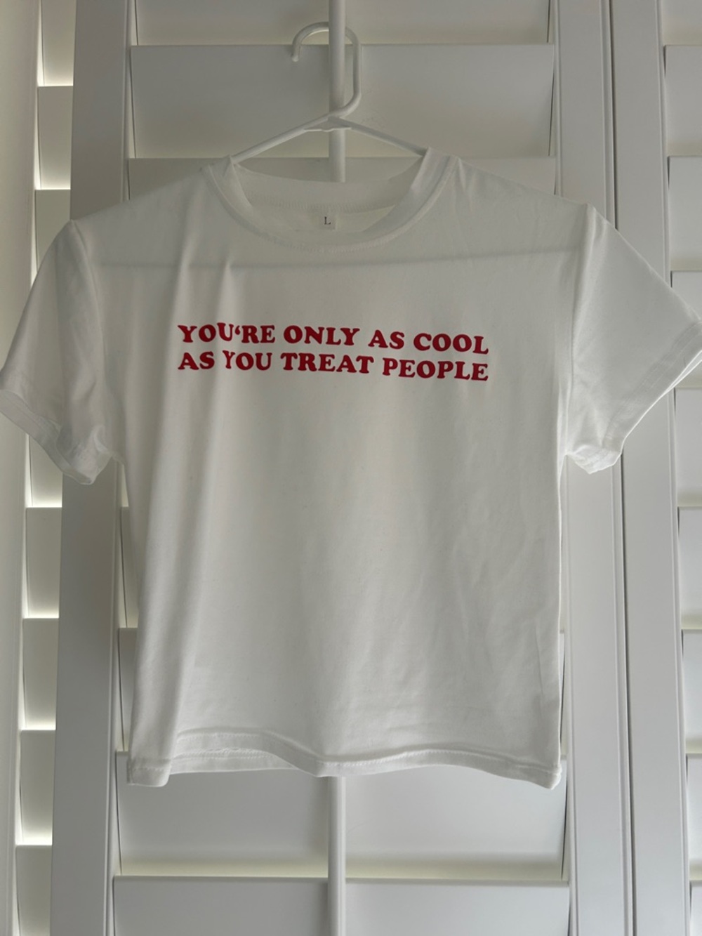 White Graphic Tee with Red Text "You're Only As Cool As You Treat People"